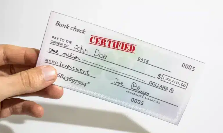 A person displaying a certified check.