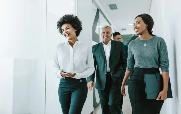A group of business people walking in an office.