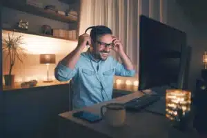 A man is listening to music on his computer at home.
