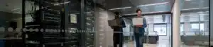 A man is standing in a server room.