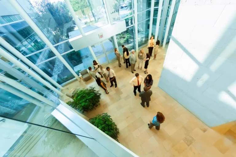 A group of people standing in the lobby of an office building.
