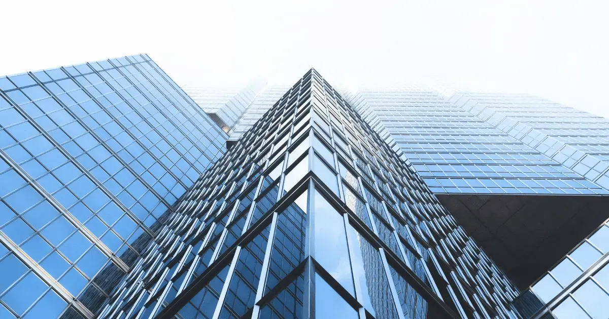 A close up view of a tall glass building.
