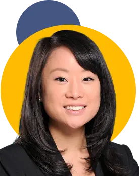 An IPO-ready asian woman smiling with a yellow background.