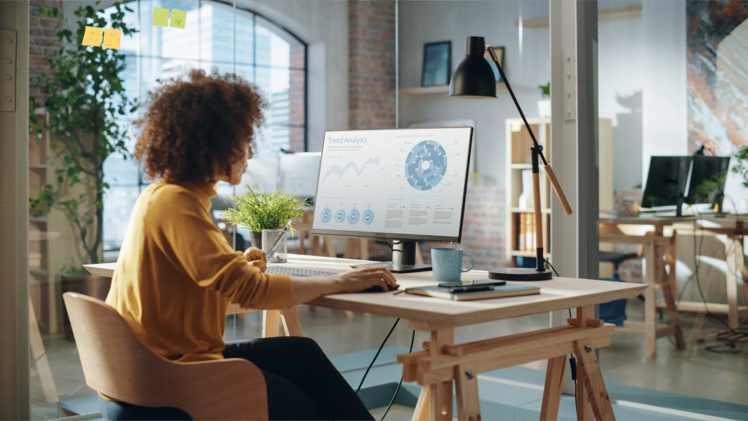 A woman working at a desk in an office.