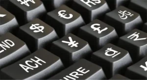Currency symbols  and International Wire Transfer Fee Calculator on a computer keyboard.