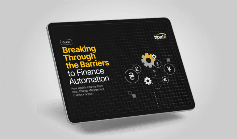 A tablet screen displays a guide titled "Breaking Through the Barriers to Finance Automation" by Tipalti, illuminating finance-related icons against a sleek black background.