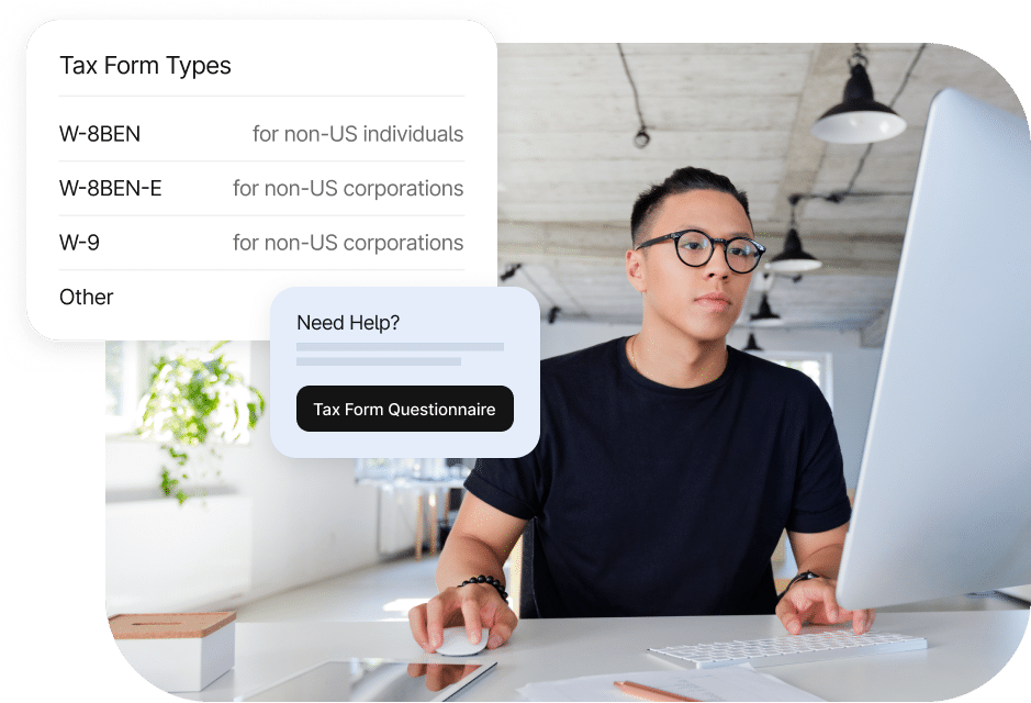 A person seated at a desk using a computer. A pop-up on the screen shows tax form types including W-8BEN, W-8BEN-E, and W-9. A help box offers a "Tax Form Questionnaire" button.