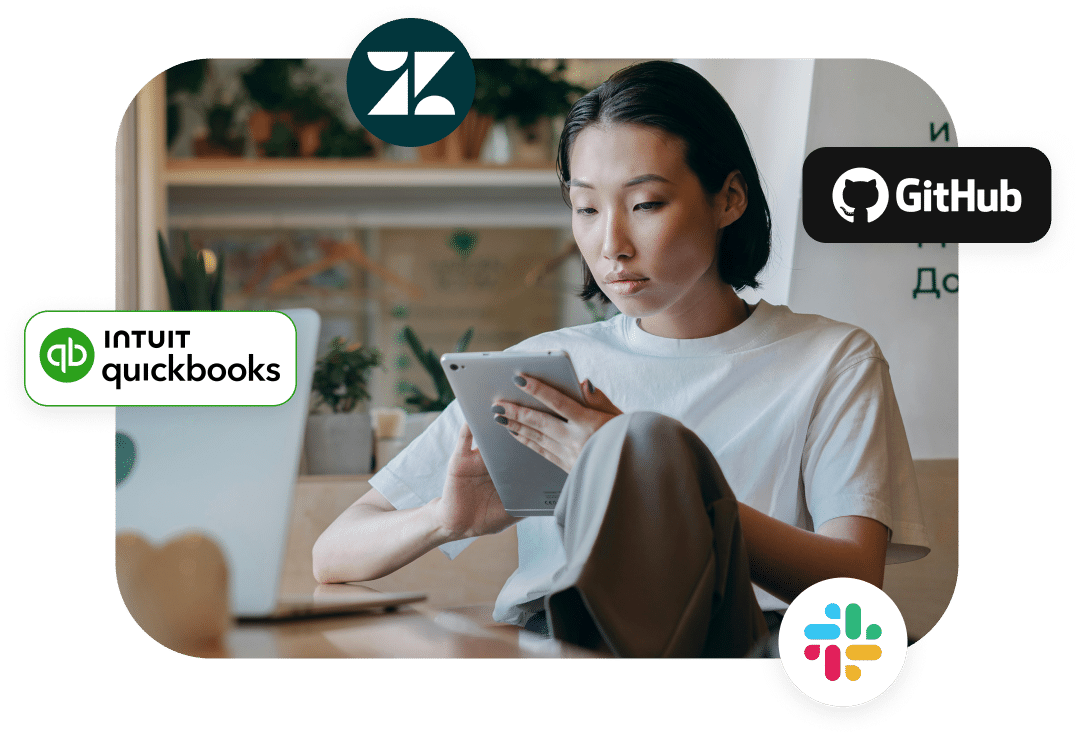 A person sitting in a casual indoor setting, looking at a tablet. Surrounding them are logos of Zendesk, GitHub, Intuit QuickBooks, and Slack.