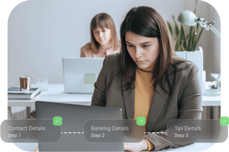 Two people working at laptops in an office. A progress tracker on the image shows steps: Contact Details, Banking Details, and Tax Details, all completed.