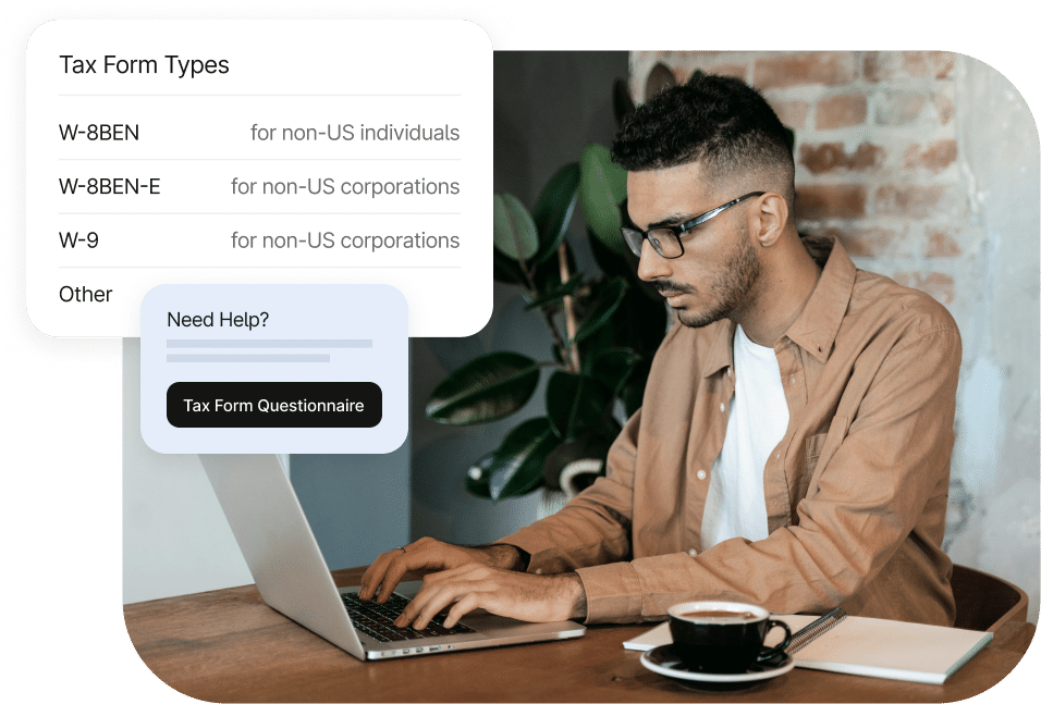 A man is typing on a laptop at a desk with tax form types displayed on the screen, including W-8BEN, W-8BEN-E, W-9, and other options. A "Need Help? Tax Form Questionnaire" button is shown.