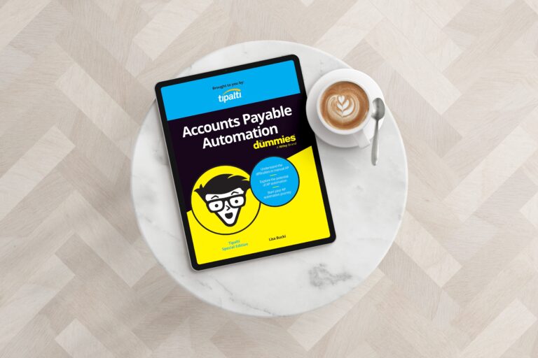 A digital tablet showing "Accounts Payable Automation for Dummies" rests on a marble table alongside a cappuccino, raising AP Awareness for 2025 with every page.